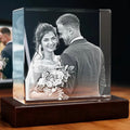 Glass photo block with a black and white image of a bride and groom on a wooden display.