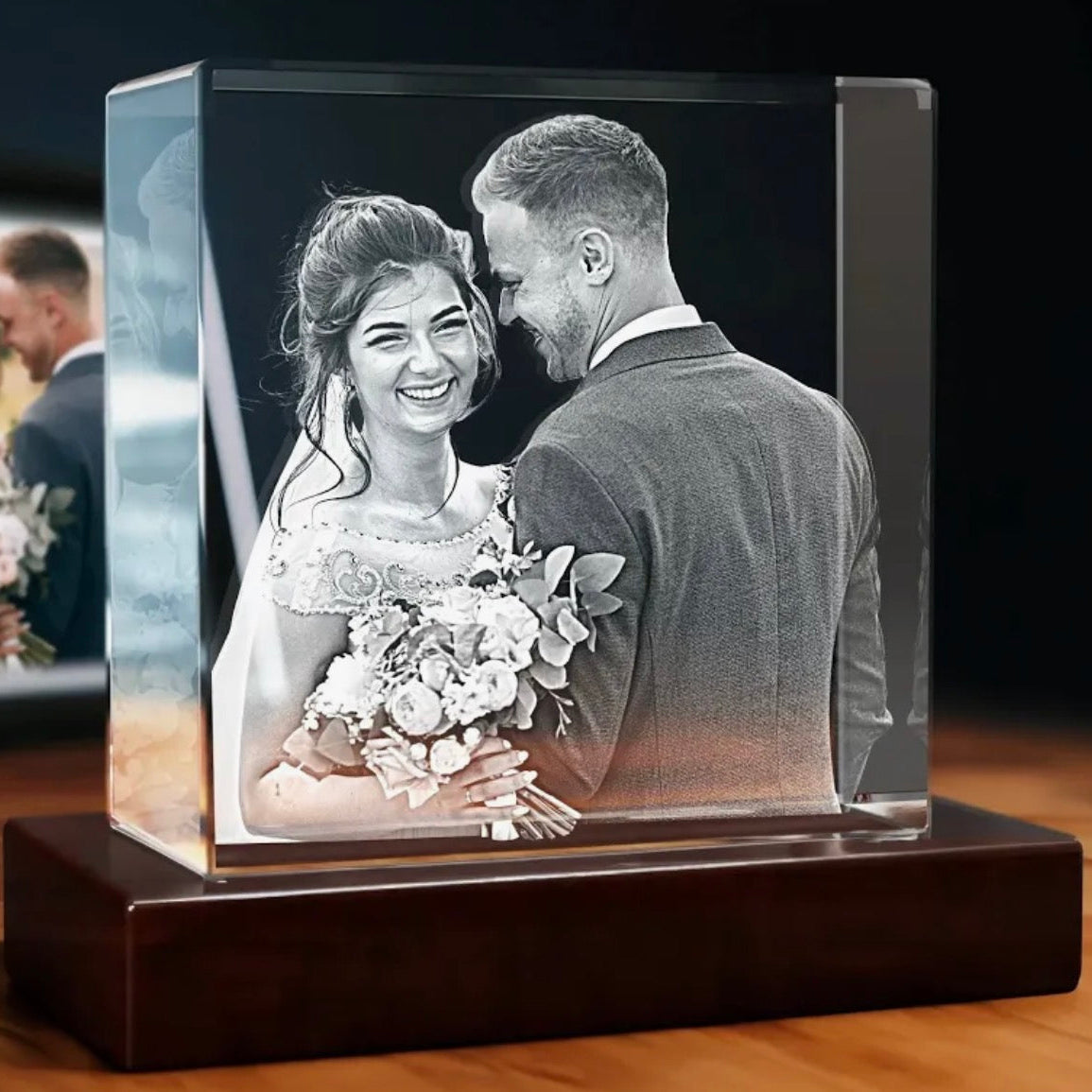 Glass photo block with a black and white image of a bride and groom on a wooden display.